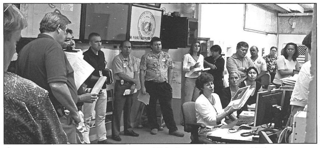 AFTER ACTIONS- State Civil Defense staffers (left) share their assessment of the week-long hurricane Exercise MAKANI PAHILI held in May.