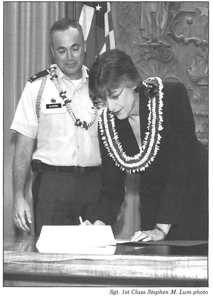 CAR BILL -- Gov. Linda Lingle, with the deploying Col. Bruce E. Oliveira, 29th Infantry Brigade Combat Team commander at her side, signs HB2605 HD2 SDl (Act 141) which provides vehicle weight tax exemptions for non-commercial vehicles registered to Hawaii residents who are members of the military, including those in the National Guard, Coast Guard and reserves.