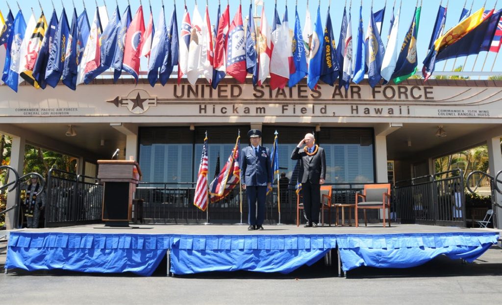 Maj. Gen. Darryll D.M. Wong, former Hawaii State adjutant general and retired Gen. Craig McKinley, former chief, National Guard Bureau, salute the Hawaii state flag during a retirement ceremony at the Distinguished Visitors reception area on Joint Base Pearl Harbor-Hickam, Hawaii, April 12, 2015. The Royal Guard, consisting of members of the Hawaii Air National Guard, present the colors for the ceremony. (U.S. Air Force photo by Airman 1st Class Robert Cabuco/Released)