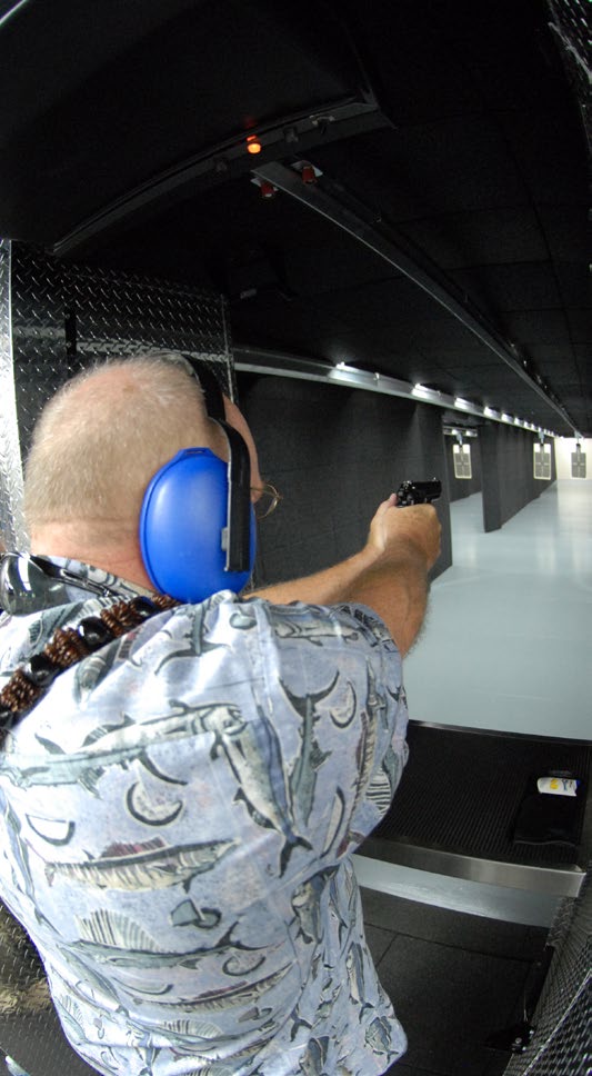 U.S. Air Force Brig. Gen. Stan Osserman (retired), former commander of the Hawaii Air National Guard, aims down range after the blessing of the 154th Security Force Squadron Indoor Firing Range at Joint Base Pearl Harbor-Hickam, Hawaii, Aug. 8, 2015.