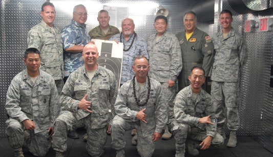 U.S. military service members participate in an ad hoc shooting competition after the blessing of the 154th Security Force Squadron Indoor Firing Range at Joint Base Pearl Harbor-Hickam, Hawaii, Aug. 8, 2015. Retired Brig. Gen. Edwin “Skip” Vincent, took first place and retired Brig. Gen. Stan Osserman, former commander of the Hawaii Air National Guard, took second place in the competition. (U.S. Air National Guard photo by Airman 1st Class Robert Cabuco)