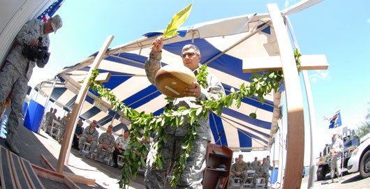 U.S. Air Force Chaplain Daniel Leatherman, 154th Wing Headquarters, performs a blessing at the 154th Security Forces Squadron (SFS) Indoor Firing Range on Joint Base Pearl HarborHickam, Hawaii, Aug. 8, 2015. The Hawaiian tradition of unraveling of the maile lei, a native Hawaiian vine with shiny fragrant leaves, is similar to a typical ribbon cutting ceremony performed at the entrance of the new facility. (U.S. Air National Guard photo by Airman 1st Class Robert Cabuco)