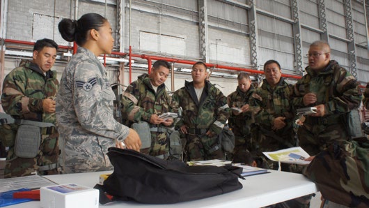 Senior Airman Famellajamie Aquino chemical biological and nuclear environment survival instructor with the 154th Civil Engineering Squadron walks Hawaii Air National Guard Airmen though a basic map reading exercise during the hands on portion of self-aid and buddy care training during August’s unit training assembly, Aug. 9, 2015, Joint Base Pearl Harbor-Hickam. (U.S. Air National Guard photo by Tech. Sgt. Andrew Jackson)