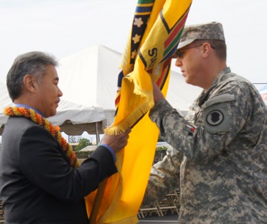 Brig. Gen. Arthur J. Logan (right) receives the Hawaii Department of Defense flag from Governor of Hawaii, David Y. Ige(center) during adjutant general transfer of authority ceremony Feb. 8, 2015 at Kalaeloa, Hawaii. - Tech. Sgt. Andrew Jackson