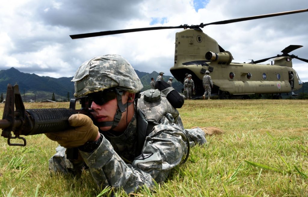 A Virginia Army National Guard soldier from Company B, 777th Aviation Support Battalion (Detachments 1,2,3) helps to establish a perimeter around a CH-47 Chinook during a downed aircraft recovery team exercise at Schofield Barracks, Hawaii, June 12, 2015. These soldiers are training to protect and recover aircraft effectively. (U.S. Army National Guard photo by Pfc. Paul D. Berzinas)