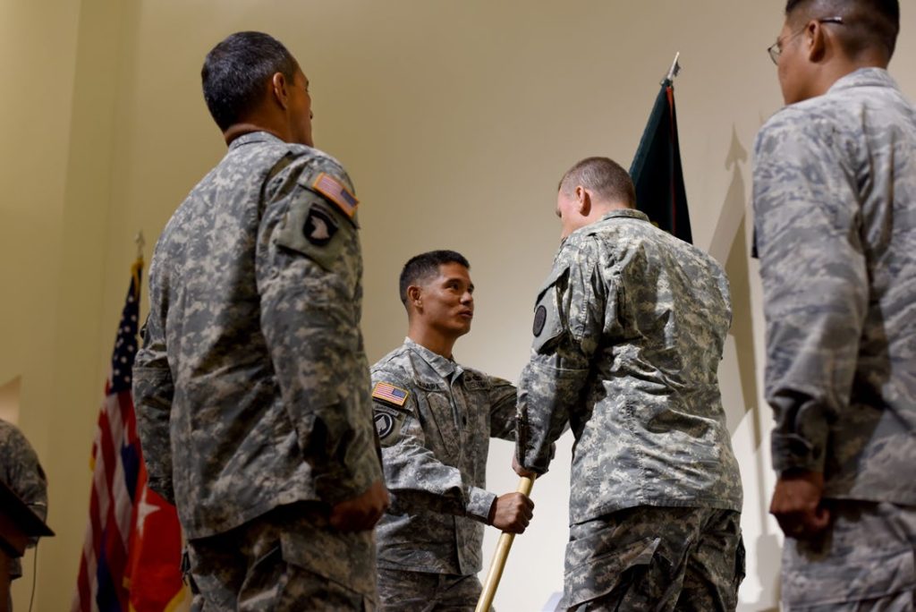 Lt. Col. Lance A. Okamura passes the 93rd Civil Support Team guidon to Maj. Gen. Joe Logan during a change of command ceremony at the 29th Infantry Brigade Combat Team headquarters in Kalaeloa, Hawaii, July 11, 2015. Okamura acted as commander of the 93rd CST for three years.