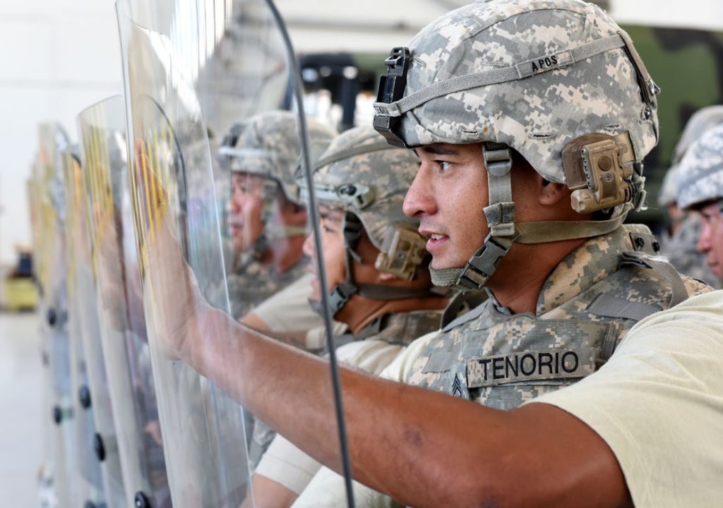 Sgt. 1st Class Jonah L. Tenorio, a wheeled vehicle mechanic with the Field Maintenance Shop 1, participated in riot shield techniques for the Quick Reaction Force of the Hawaii Army National Guard June 26, 2015, at Kalaeloa, Hawaii. The QRF consists of full-time technicians of the HIARNG that must prepare within a moment’s notice to assist with natural disasters in the State of Hawaii, as well as, assist with traffic control, securing landmarks and riot control. (U.S. Army National Guard photo by Staff Sgt. Ryan Sheldon)