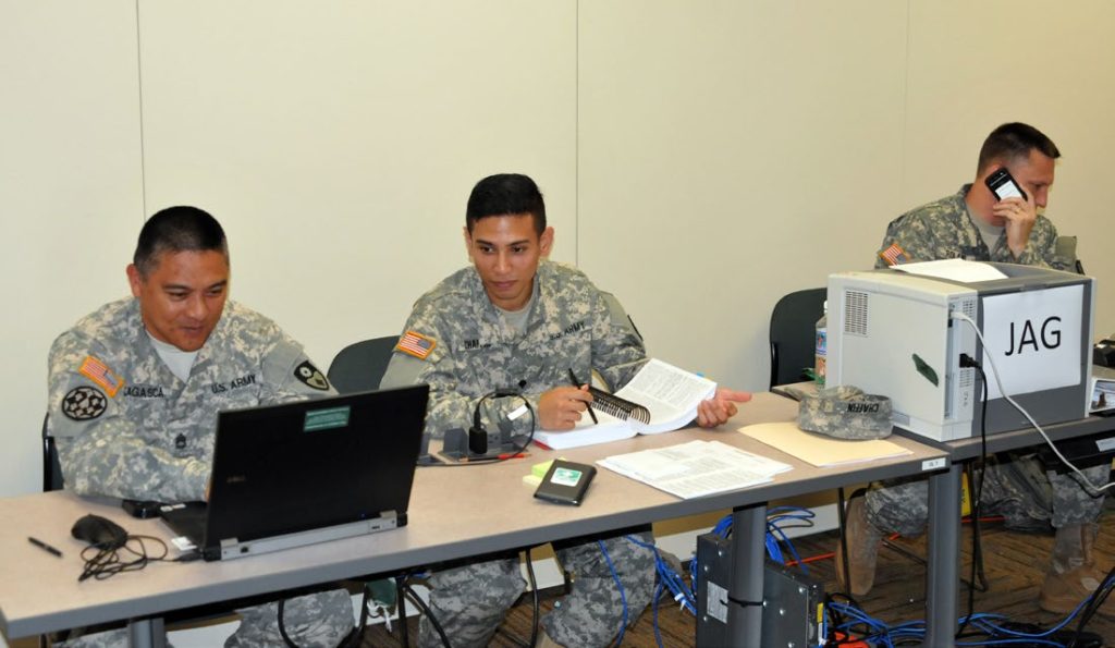 Staff Sgt. Bernie Lagasca, Spc. Sean Chaffin and Capt. Matthew Roland, Judge Adjutant General personnel with the California Army National Guard 49th Military Police Brigade (Homeland Response Force) work at the JAG desk at the tactical operations center June 6 during Vigilant Guard/Makani Pahili 2015 in Oahu, Hawaii. The JAG was responsible for researching legal authorities for the deployment of the HRF outside California, preparing documents and legal memos and ensuring that all units understand the rules for the use of force in Hawaii. (U.S. Army National Guard photo/ Sgt. Brianne M. Roudebush/ Released)