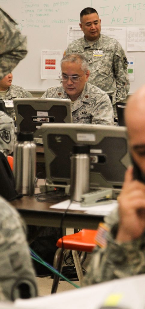 Hawaii Air National Guard Maj. Dana Uehara, 199th Weather Flight, discusses weather forecasts with leadership during exercise Vigilant Guard/Makani Pahili 2015 at the Joint Task Force 5-0 command center in the Hawaii National Guard (HING) Diamond Head Headquarters, Hawaii, June 2, 2015. Uehara interprets Terminal Aerodrome Forecasts (TAFs) released by the National Weather Service and the Central Pacific Hurricane Center to produce his assessment. (U.S. Air National Guard photo by Airman 1st Class Robert Cabuco)