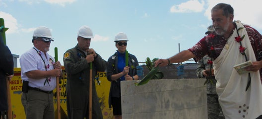 Officials for the Hawaii Air National Guard look on as Hawaiian “Kahu” or priest Roy Brooks performs a traditional Hawaiian blessing on the cornerstone pillar of a future solar array facility being built at Joint Base Pearl Harbor-Hickam, Oct. 27, 2015. The solar array facility will be one piece of the HIANG’s renewable energy strategy to decrease it’s electricity expense and increase it’s energy security. (U.S.Air National Guard photo by Senior Airman Orlando Corpuz/ Released)