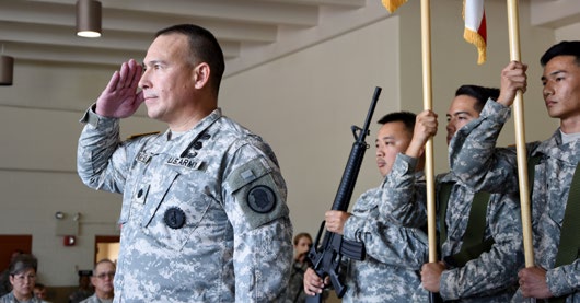 Lt. Col. Courtney Vares-Lum salutes the official party during the 103rd Troop Command change of command at the Hawaii Army National Guard armory Oct. 4, 2015. Vares-Lum acted as commander of troops for the ceremony. (U.S. Army National Guard photo by Pfc. Paul D. Berzinas/Released)