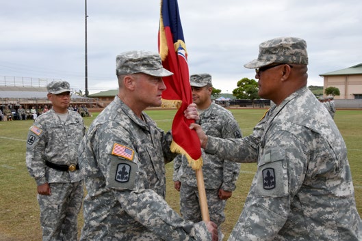 Col. Stephen F. Logan prepares to relinquish the 29th Infantry Brigade Combat Team guidon to Col. Moses Kaoiwi, Jr. during the 29th Infantry Brigade Combat Team change of command ceremony in Kapolei, Hawaii, Oct. 4, 2105. Brig. Gen Keith Y. Tamashiro, commander of the Hawaii Army National Guard, facilitated the exchange. (U.S. Army National Guard photo by Pfc. Paul D. Berzinas/Released)