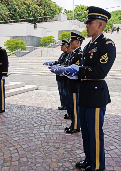 Hawaii Army National Guard Honor Guard Soldiers hold the American flags that were flown over Arlington National Cemetery and the like.