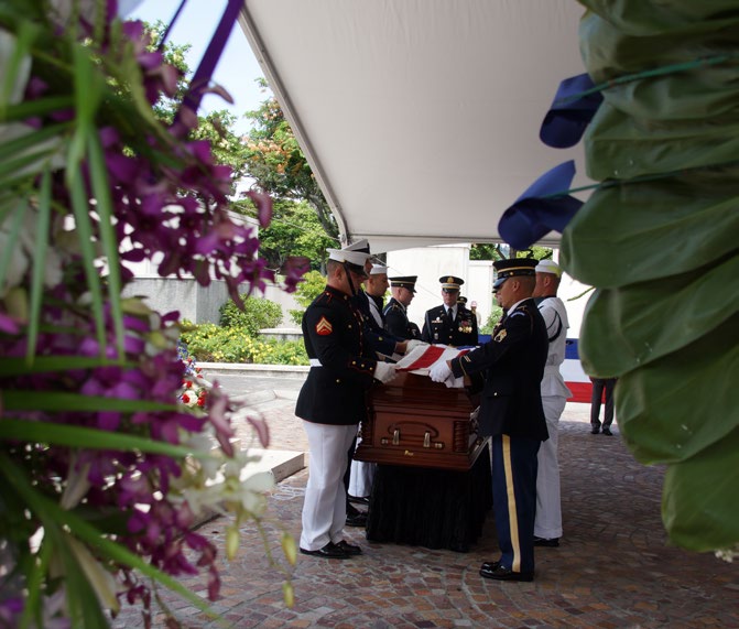 Honor Guards from the military services fold the American flag.