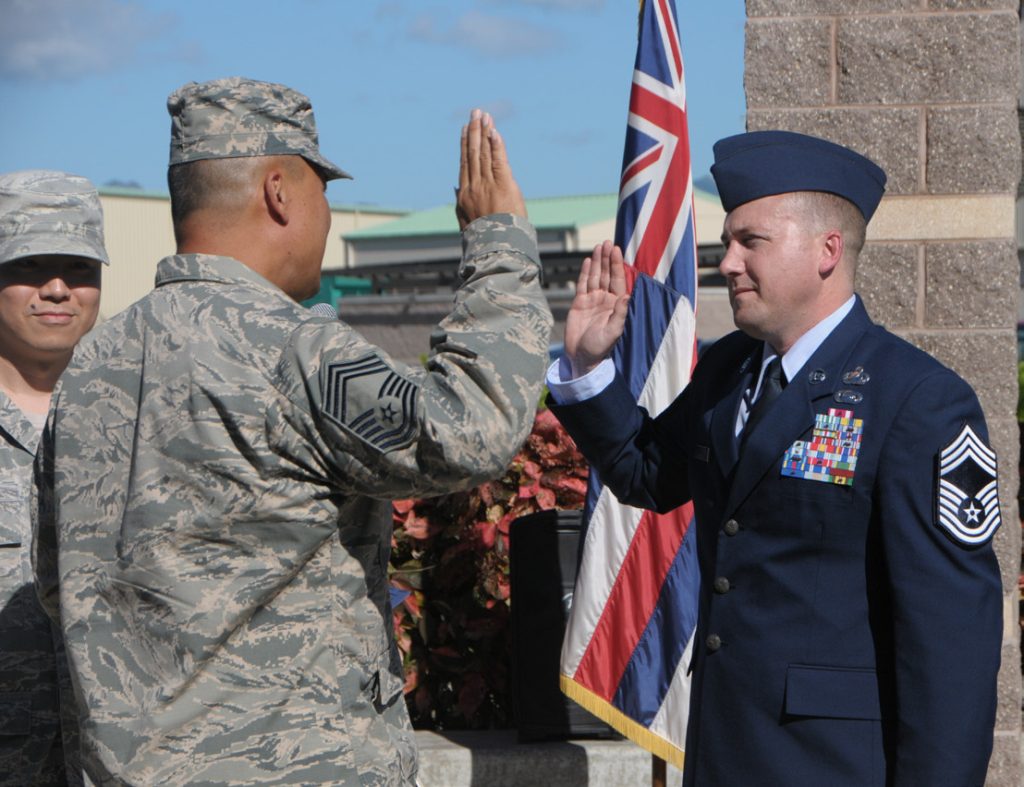Chief Master Sgt. Paul K. Kamakawiwoole administers the Chief’s Oath to Chief Master Sgt. Broc Richardson during a promotion ceremony at Joint Base Pearl Harbor-Hickam, Hawaii, Jan. 9, 2016. Chief Master Sergeants make up only two percent of the total enlisted force of the Air Force. (U.S. National Guard photo by Airman 1st Class Robert Cabuco/released)