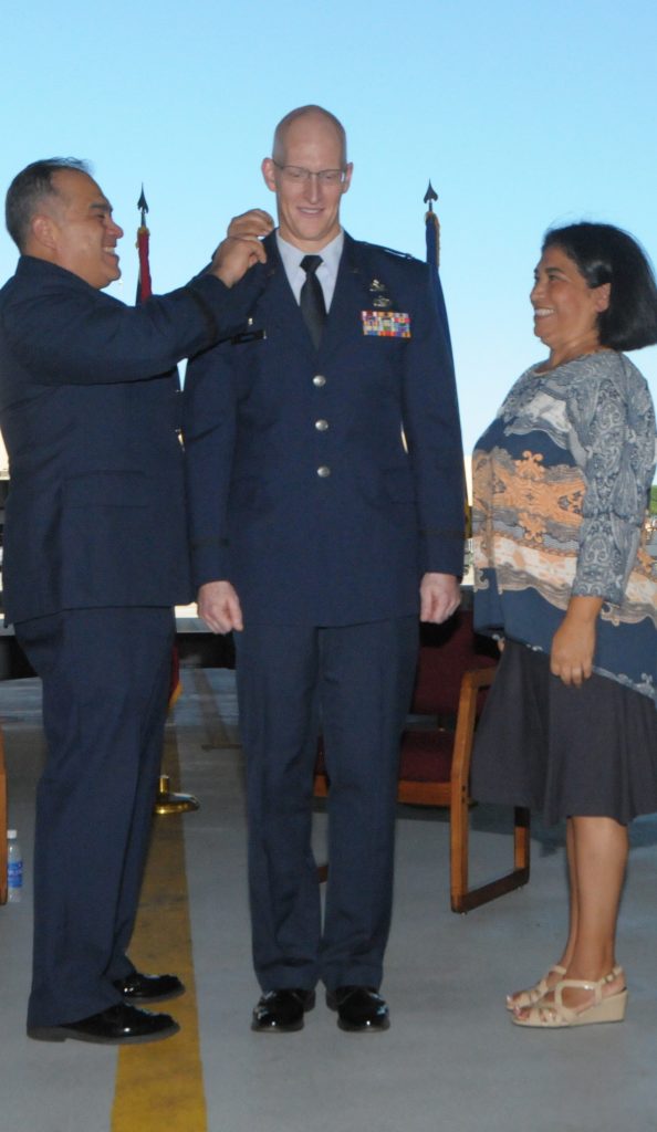 U.S. Air Force Col. Joseph Harris, commander of the 154th Maintenance Group, is pinned by Brig. Gen. Braden Sakai, commander of the 154th Wing, and his wife, Sara, during his promotion ceremony at Joint Base Pearl Harbor-Hickam, Hawaii, Jan. 10, 2016. Harris celebrates 31 years of service with the Air Force. (U.S. Air National Guard photo by Airman 1st Class Robert Cabuco/released)