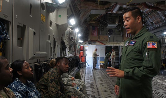 U.S. Air Force Capt. Reinier Villanueva, pilot with the 204th Airlift squadron conducts a safety brief with passengers before a low flying maneuver flight on a C-17 Globemaster III during exercise Balikatan 2016, Clark Air Field, Philippines, April 15, 2016.