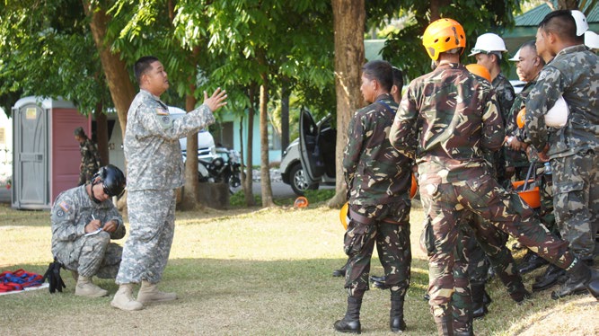 Staff Sgt. Cory Ito, Hawaii National Guard CERFP team, collects an after action report from members of the Armed Forces of the Philippines after their second day on the ropes rescue course during an Urban Search and Rescue subject matter exchange with the Hawaii National Guard CERFP team during Balikatan 2016, April 11, 2016, Camp Capinpin, Philippines.