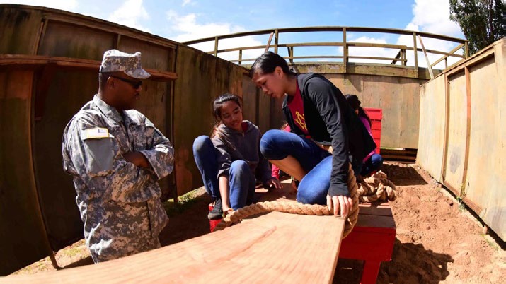 Sgt. 1st. Class John Paul Jones, Hawaii Army National Guard Recruiting and Retention Non-Commissioned Officer, mentors Prince David Kawananakoa Middle School students while navigating as a team through an obstacle course at the Schofield Barracks Leadership Reaction Course on Oct. 28, 2016. The LRC is an obstacle course that challenges the mental and physical strengths of all participants while teaching teams to work together to navigate through each obstacle. Since 2012, the Hawaii Army National Guard has collaborated with President Theodore Roosevelt High School Junior Reserve Officer Training Corps and Kawananakoa Middle School faculty to host this event.