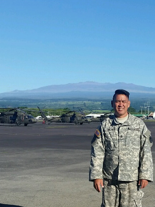 MAN AND MACHINE– Staff Sgt. Gregory A.Y. Lum Ho Jr. on Lyman Air Field with UH-60M Blackhawks in the background.