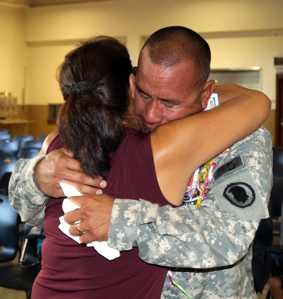 A Soldier from the 297th Engineer Detachment Fire Fighting Team embraces a loved one during the deployment ceremony at the 103rd Troop Command Armory in Pearl City, Hawaii on July 18, 2017. The Fire Fighting Team’s mission is to provide fire protection for aviation assets and major facilities in any theater of operations. (U.S. Army National Guard photo by Spc. Lisa K. Lariscy)