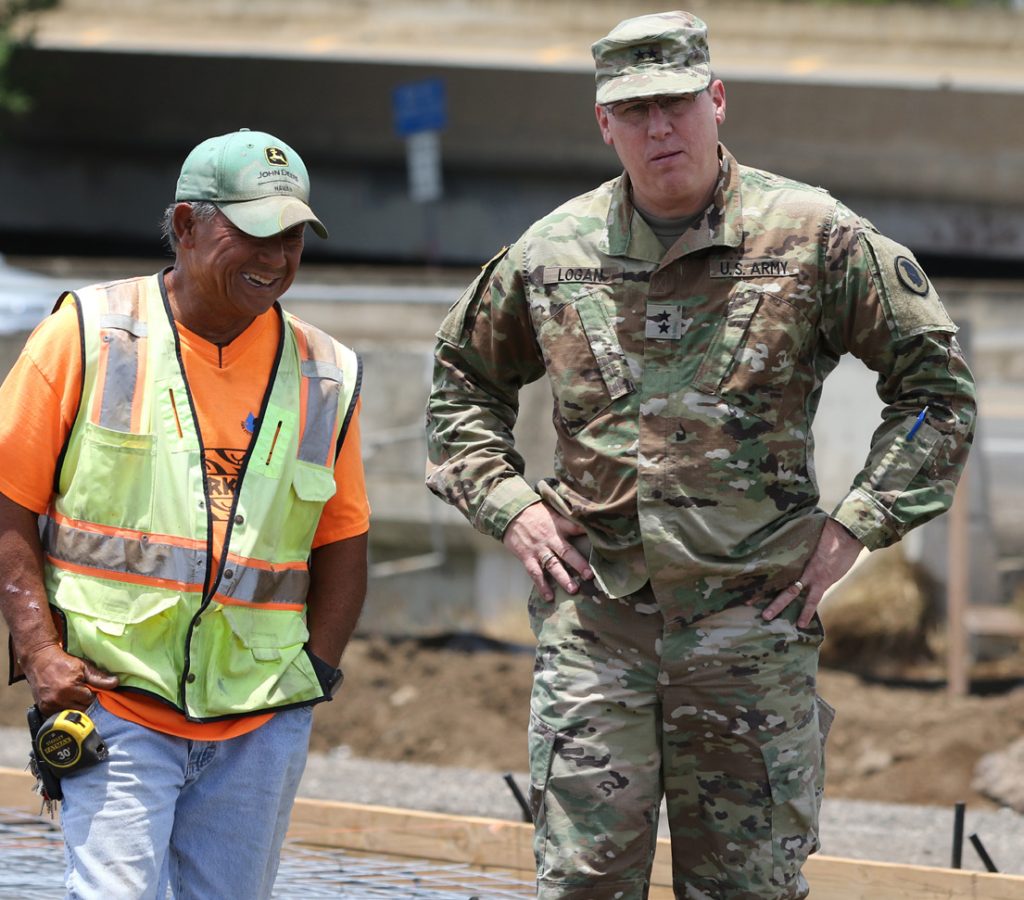 Maj. Gen. Arthur J. Logan is briefed by a civilian contractor on the details of the Kahauiki Village Project in Honolulu, Hawaii on Aug. 9, 2017. Logan arrived to oversee the progress of the soldiers working alongside the civilian contractors to build a community for homeless families. (U.S. Army National Guard Photo by Pfc. Chavaughn Washington)