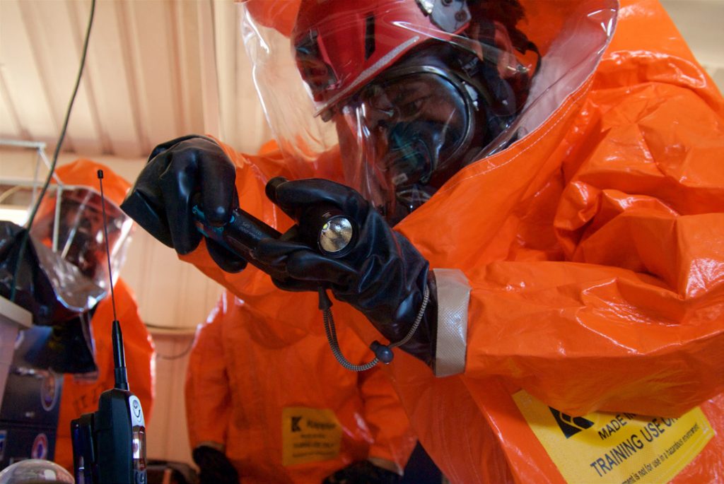 A Joint Hazard Assessment Team takes hazmat instrument readings in a simulated hot zone during Kauai County Exercise 2017, Pacific Missile Range Facility, Kauai, Aug. 29, 2017. JHAT teams are tasked with gathering intel and environmental conditions in hazmat hot zones. KCE17 was a Hazmat threat and response exercise that brought together federal, state, and county agencies to respond to simulated CBRNE incidents. (U.S. Air National Guard photo by Senior Airman Orlando Corpuz)