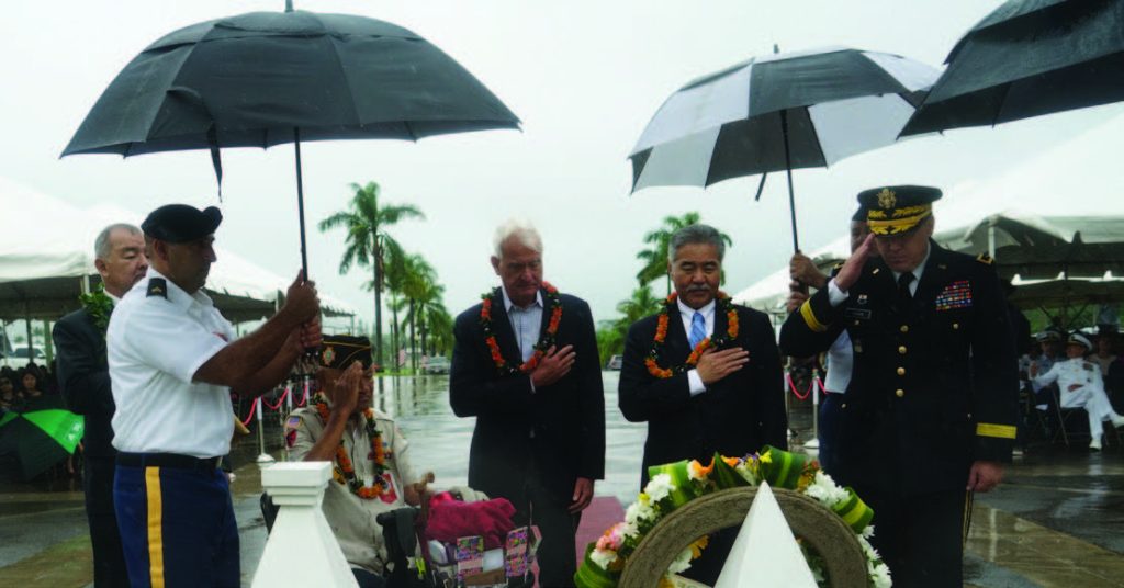 Right to Left: Adjutant General Arthur Logan, Governor David Ige, and Honolulu Mayor Kirk Caldwell salute a wreath honoring veterans during the Veterans Day ceremony hosted at the Hawaii State Veterans Memorial Cemetery in Kaneohe.