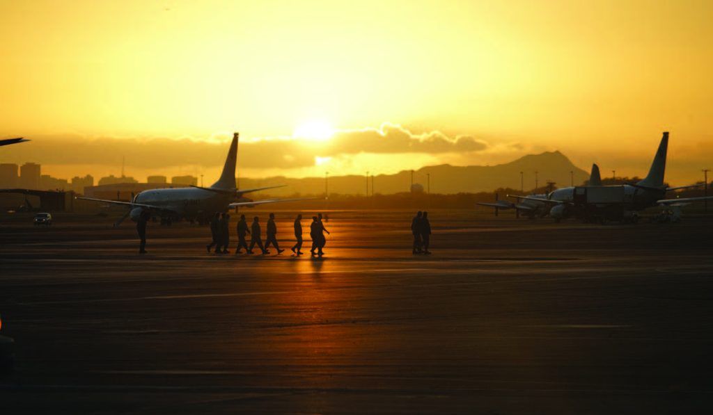 Members of Hawaii National Guards 203rd Air Refueling Squadron perform a FOD walk on the morning of December 7th, before the base-wide remembrance activities.