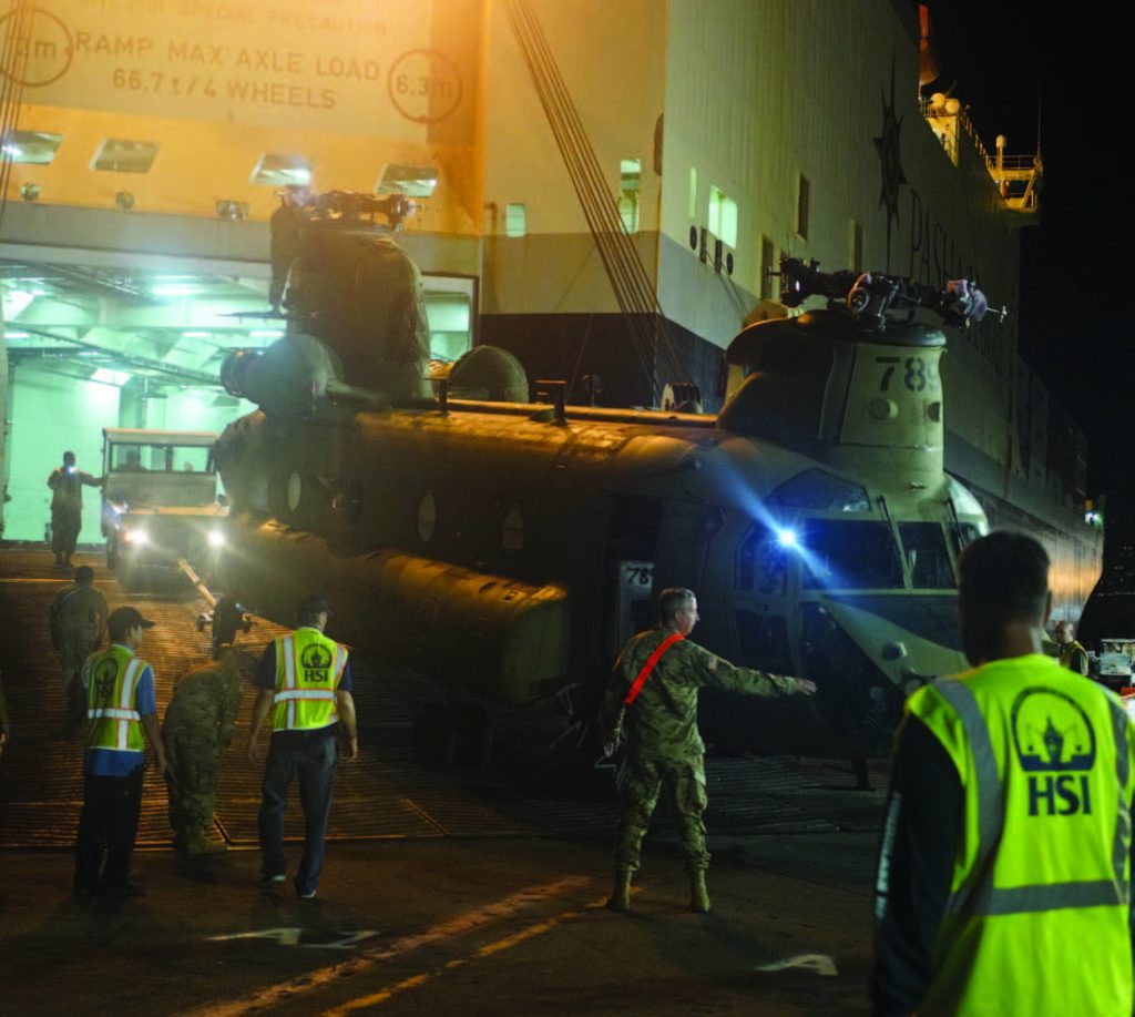 Hawaii Army National Guard CH-47 Helicopters assigned to the Company B, 1st Battalion, 171st Aviation Regiment are rolled on to a commercial shipping vessel. March 19, 2018, Honolulu Harbor (U.S. National Guard Photo by Tech. Sgt. Andrew Jackson)