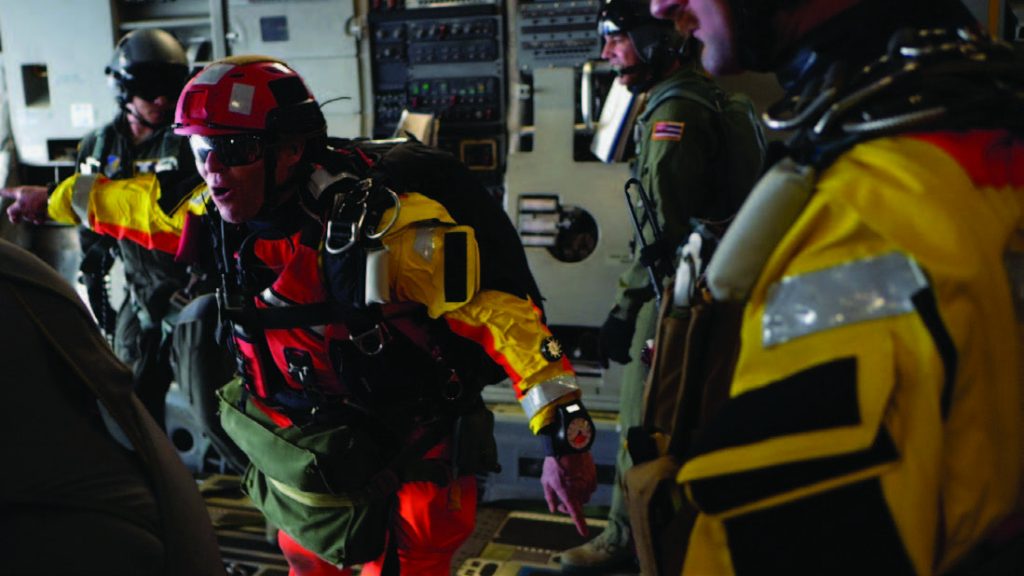 Tech. Sgt. Westley Loignon, 103rd Rescue Squadron para-rescueman and jump master, instructs his team to jump off a C-17 Globmaster III March 4, 2017, off the coast of Oahu, Hawaii. The jump training was held with members of Hawaii Air National Guard’s 204th Airlift Squadron in an effort to test their long-range search and rescue capabilities. In this training scenario, the two squadrons teamed up to practice the rescue of a downed astronaut crew. (U.S. Air National Guard photo by Senior Airman John Linzmeier)