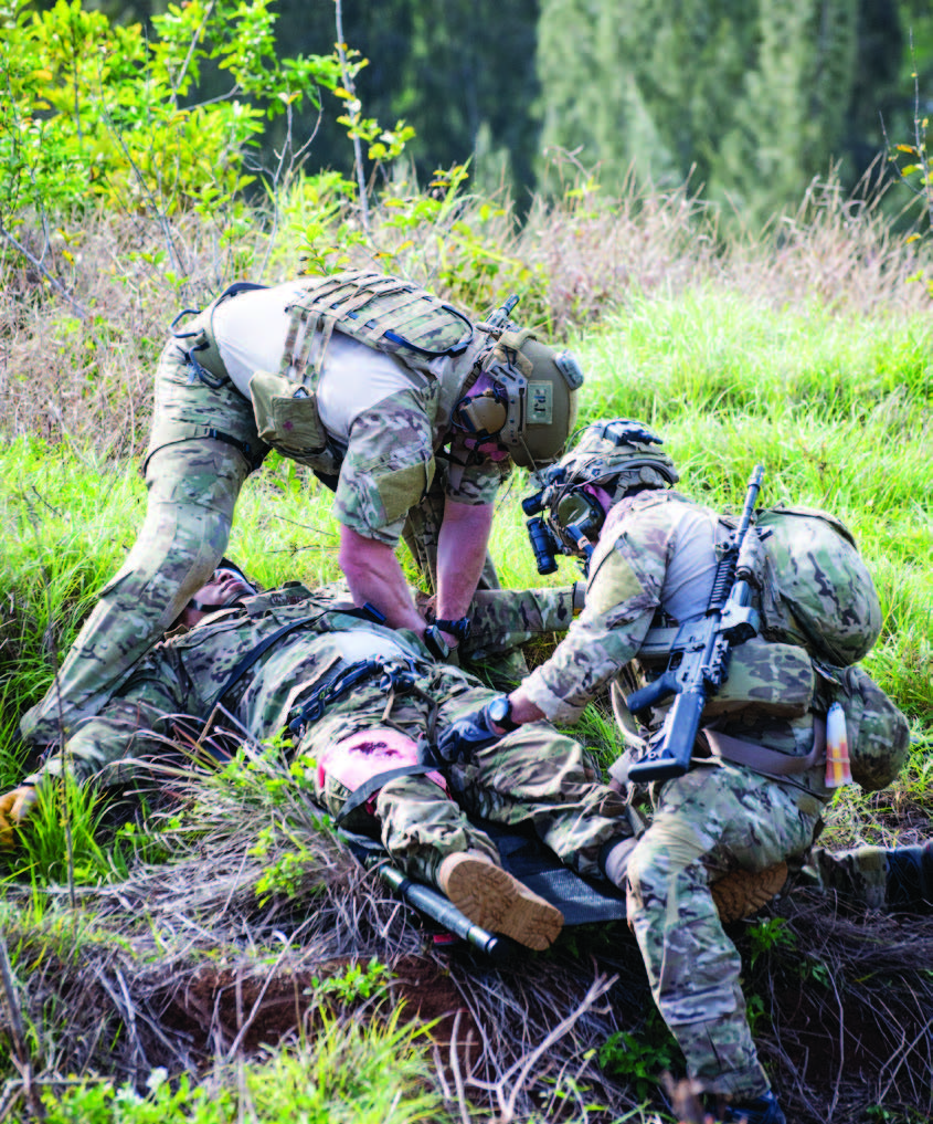 Two Airmen assess a mock casualty.