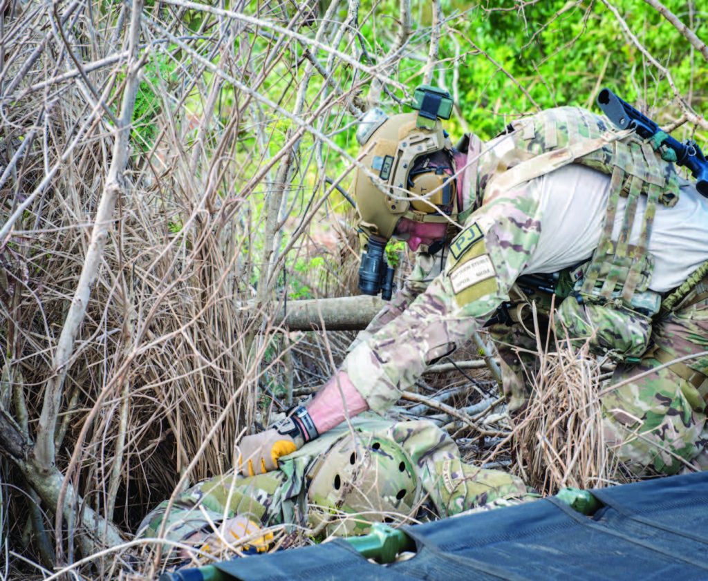 Staff Sgt. Matthew J. Steible assesses a mock casualty.