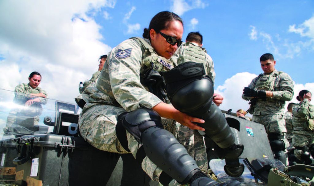 Tech Sgt. Tashalynn Willing, 154th Security Forces Squadron fire team member, puts on personal protective equipment during Patriot South exercise, Feb. 15, 2018, at Camp Shelby, Miss. The participating Airmen were temporarily ‘deputized’ by local police in order to serve as back-up support through the events of a simulated earthquake. (U.S. Air National Guard photo by Staff Sgt. James Ro)