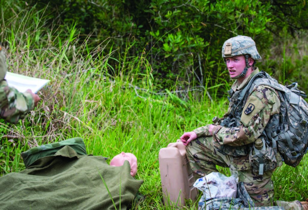 Pfc. William I. Brady of 3rd Platoon, Alpha Troop, 1st Squadron, 299th Calvary Regiment simulated treating a casualty during the Best Warrior Competition at Schofi eld Barracks, Hawaii Mar. 3, 2018. The Best Warrior Competition recognizes Soldiers who demonstrate commitment to the Army Values, embody the Warrior Ethos, and represent the Force of the Future. (U.S. Army National Guard Photo by Sgt. Amanda Gerlach)