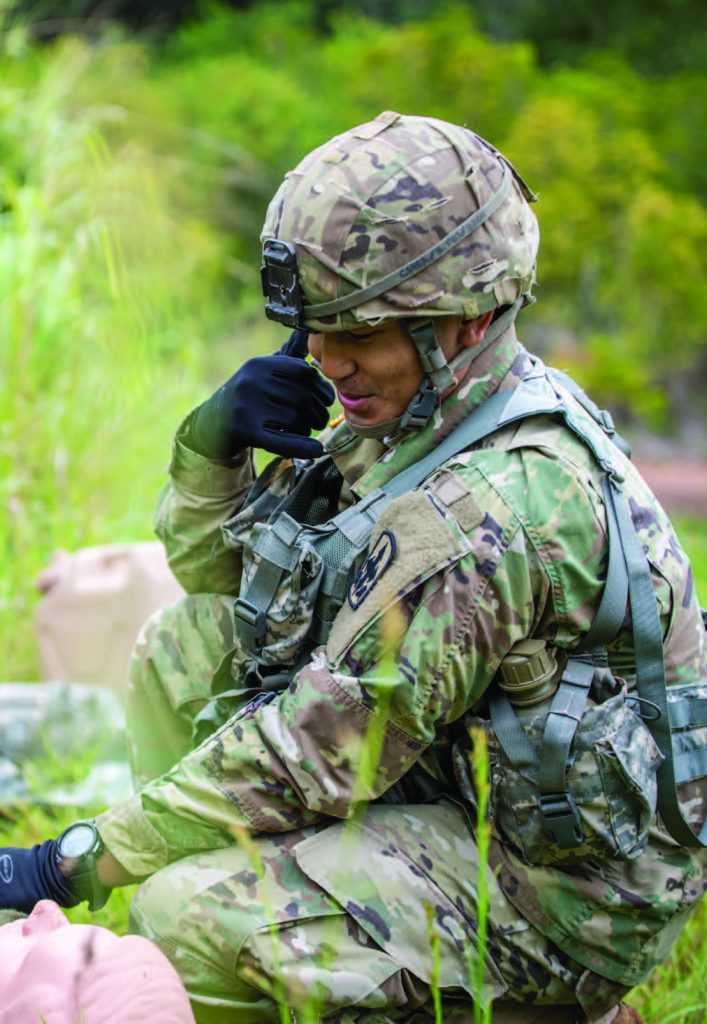 Sgt. William A. Chea of 1st platoon, Bravo Troop, 1st Squadron, 299th Cavalry Regiment simulates calling in a 9-line medical evacuation during the Best Warrior Competition at Schofield Barracks, Hawaii Mar. 3, 2018. (U.S. Army National Guard Photo by Sgt. Amanda Gerlach)