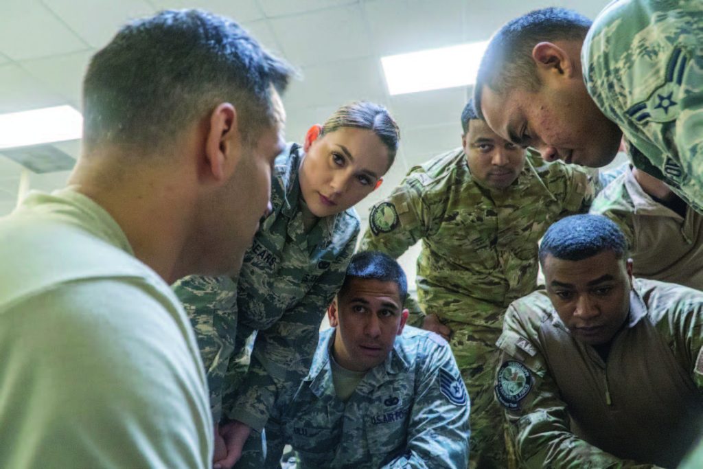 Master Sgt. Jose Alveida (left), 165th Air Support Operations Squadron, provides instruction to members of the 154th Security Forces Squadron and the Mississippi Department of Wildlife, Fisheries and Parks Special Response Team Feb. 12, 2018, at Gulfport Combat Readiness Training Center, Mississippi. Alveida taught various life-saving practices from the Tactical Combat Casualty Course, such as administering tourniquets, quick-clots and a method of needle decompression in order to treat a sucking-chest wound. (U.S. Air National Guard photo by Staff Sgt. James Ro)