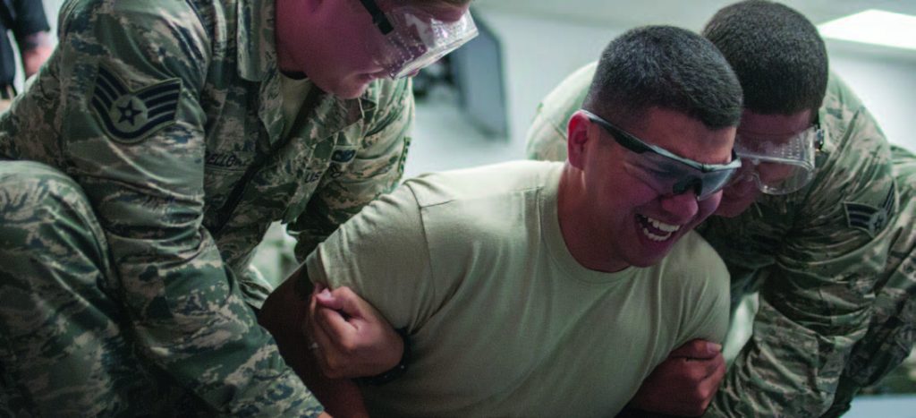 Airman 1st Class David Lovell, 154th Security Forces Squadron fireteam member, gets stunned during a taser certification course Feb. 10, 2018, at Gulfport Combat Readiness Training Center, Miss. Tasers are used to temporarily cause neuromuscular incapacitation that contracts the muscles, causing them to lock up making the individual unable to move. (U.S. Air National Guard photo by Senior Airman John Linzmeier)