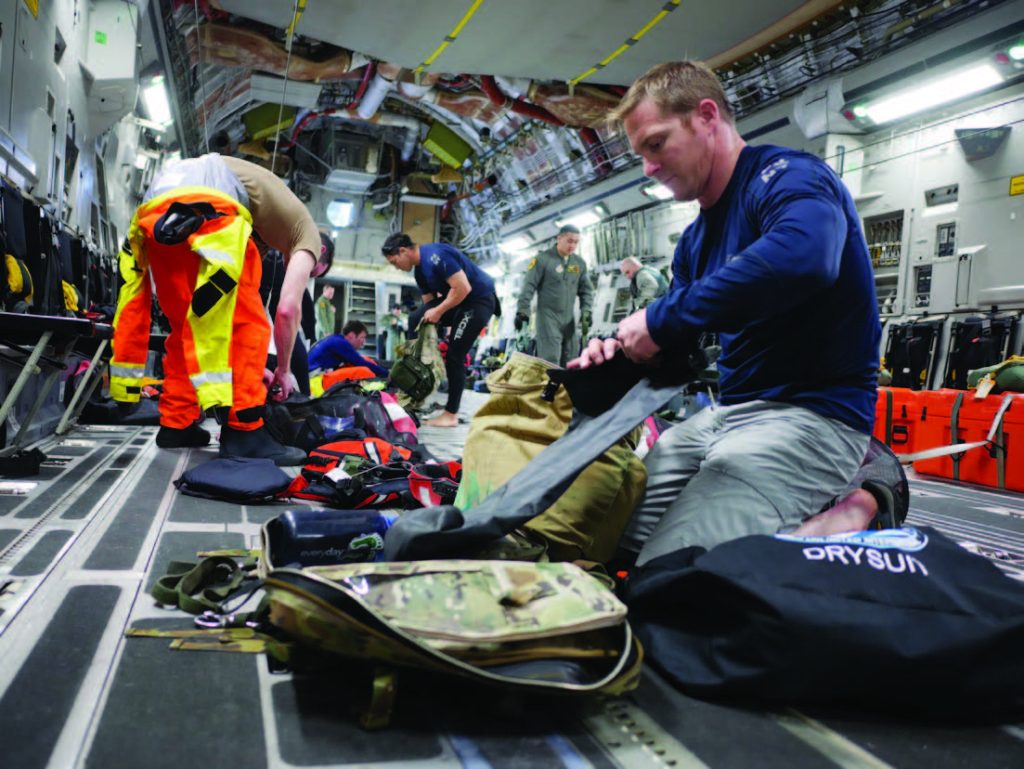 Tech. Sgt. Westley Loignon, 103rd Rescue Squadron para-rescueman and jumpmaster, prepares his life support equipment aboard a C-17 from the 204th Airlift Squadron March 4, 2017, at Joint Base Pearl Harbor-Hickam, Hawaii. As a jumpmaster, Loignon’s team depends on his experience and leadership to ensure everyone safely lands in the targeted drop zone. In this training scenario, the Hawaii Air National Guard and New York Air National Guard teamed up to practice the rescue of a downed astronaut crew. (U.S. Air National Guard photo by Senior Airman John Linzmeier)