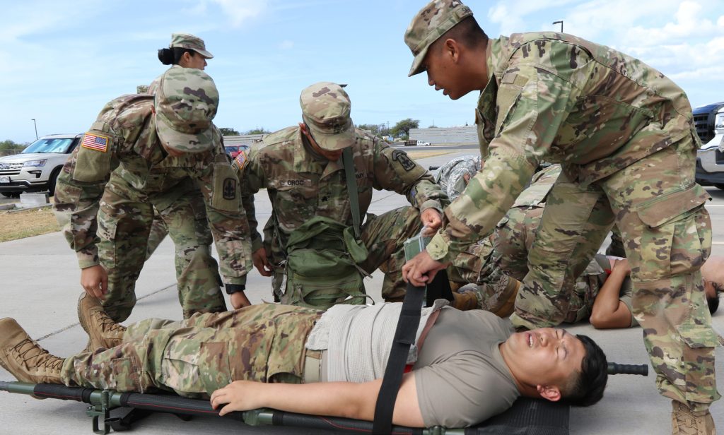 Soldiers of the 29th Infantry Brigade Combat Team simulate tactical combat casualty care and evacuation procedures during annual training on August 21, 2018 at Kalaeloa, Hawaii. The training prepares the 29th IBCT Soldiers for an upcoming deployment. (U.S. Army National Guard. Photo by Sgt. Tinisha Mellein-Fortson/Released