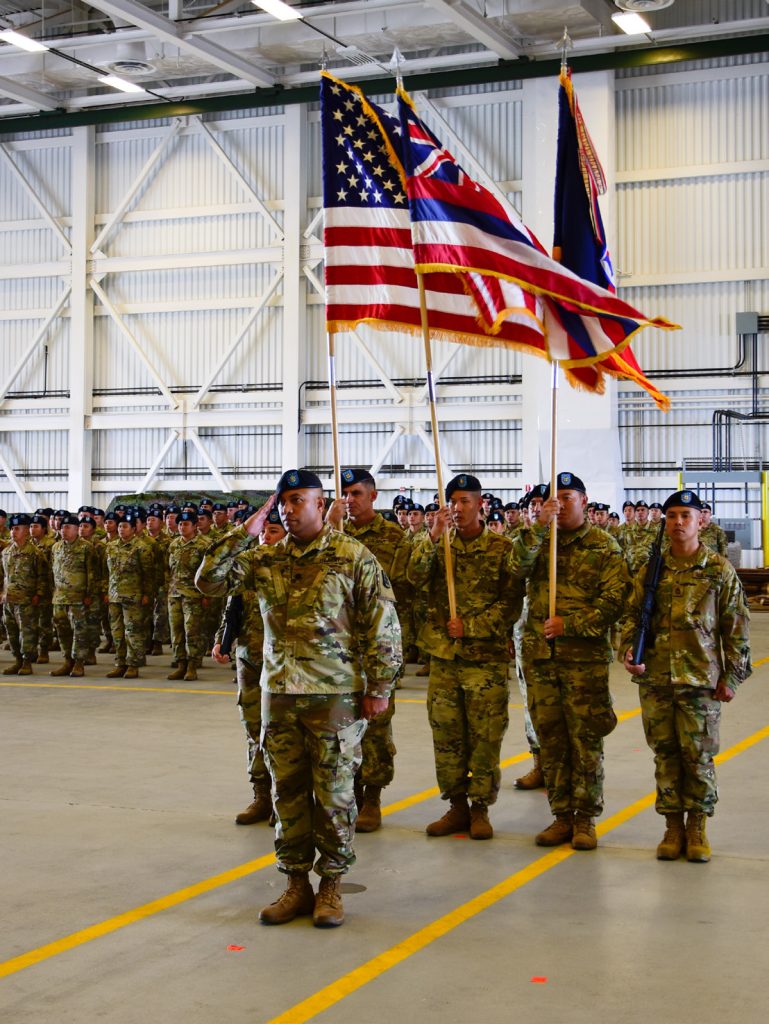 Soldiers from 29th Infantry Brigade Combat Team, Hawaii Army National Guard stand at attention during their deployment ceremony at the Kalaeloa Army Aviation Support Facility on August 26, 2018. The 1-299th CAV will be deploying to Sinai, Egypt supporting the Multinational Force and Observers while the 29th IBCT will be deploying to Kosovo in support of Multinational Battle Group East Kosovo Forces (KFOR). (U.S. Army National Guard photo by Sgt. 1st Class Theresa Gualdarama)