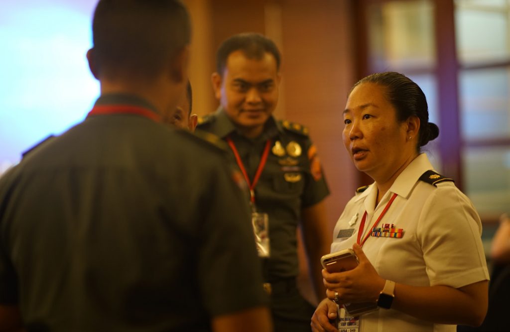 Hawaii Army National Guard, Maj. Lauren Sodetani-Yoshida, talks strategy with her counterparts from the Tentara Nasional Indonesia on the second day of Gema Bhakti as the focus of the staff planing exercise shifted from academic to execution, Sept. 18, 2018, Jakarta Indonesia. (U.S. Air National Guard Photo by Tech. Sgt. Andrew Jackson)