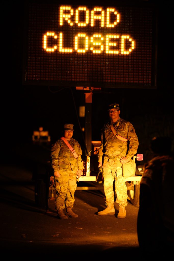 Hawaii Army National Guard Soldiers, PV2 Russel Tabandera and PFC Mariel Calivoso, man a road closure point outside Leilani Estates in assistance to the Hawaii Police department efforts to control access to the lava stricken neighborhood, Pahoa Hawaii, May 06, 2018. (U.S. Air National Guard Photo By Tech. Sgt. Andrew Jackson)