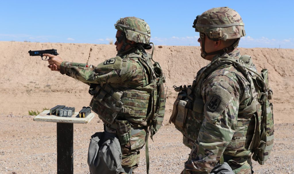 Spc. Janis K. Poole, a human resource specialist with the 29th Infantry Brigade Combat Team (IBCT) receives coaching from 1st Sgt. Brandon Kumalae, of the Headquarters Headquarters Company (HHC), while participating in M9 pistol safety training and familiarization on Oct. 3, 2018 at Dona Ana Range Complex, New Mexico. The training prepares the 29th IBCT Soldiers to deploy to Kosovo in support of Multinational Battle Group East Kosovo Forces (KFOR). KFOR is a NATO-led international peacekeeping force, which is responsible for establishing a secure environment in Kosovo. (Hawaii Army National Guard Photo by Sgt. Tinisha Mellein Fortson/Released)