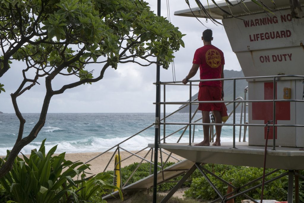 Senior Airman Casey Whitworth, a full-time lifeguard and triage response team member of the Hawaii Air National Guard, monitors Pyramid Beach November 20, at Marine Corpse Base Hawaii. He was posted near this spot on October 22, when he was called to help rescue the victims of a commercial helicopter crash. All three victims were saved. As a member of the 154th Medical Group’s Chemical, Biological, Radiological, Nuclear, High Yield Explosive Enhanced Response Force Package (CERFP), Whitworth says his military experience has made him a more competent and attentive lifeguard. (U.S. Air National Guard photo by Senior Airman John Linzmeier)