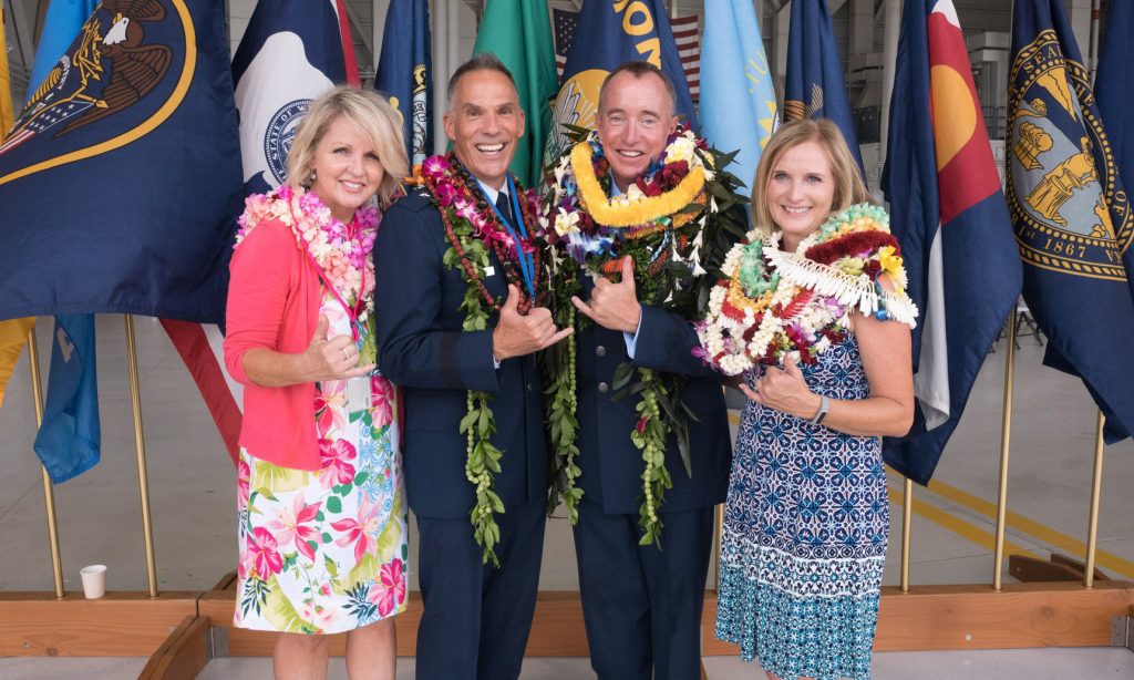 Brig. Gen. Gregory Woodrow outgoing 154th Wing Commander and family with Col. Dann S. Carlson in-coming 154th Wing Commander and family pose for an aloha shaka after the change of command ceremony, August 04, 2019 (U.S. Air National Guard photo by Capt. Justin Leong)