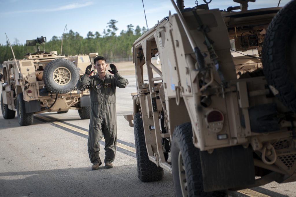 Staff Sgt. Sean Chang, 204th Airlift Squadron loadmaster, guides a U.S. Army High Mobility Multipurpose Wheeled Vehicle onto a C-17 Globemaster III Jan. 21, 2019, at Camp Shelby Joint Forces Training Center near Hattiesburg, Miss. Members of the Hawaii Air National Guard transported personnel and vehicles to the Gulfport Combat Readiness Training Center, Miss., during exercise Southern Strike. (U.S. Air National Guard photo by Senior Airman John Linzmeier)