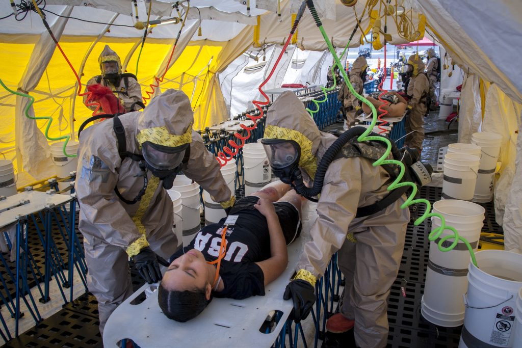 Hot-zone team members from Hawaii’s Chemical, Biological, Radiological, Nuclear, and High-Yield Explosive, EnhancedResponse-Force-Package Team (CERFP) process simulated casualties through a non-ambulatory decontamination zone during an evaluation exercise March 9, 2019, at Kalaeloa, Hawaii. Upon completion of the training, members of the National Guard Bureau Joint Interagency Training and Education Center presented the validation to the Hawaii National Guard Adjutant General. (U.S. Air National Guard photo by Senior Airman John Linzmeier)