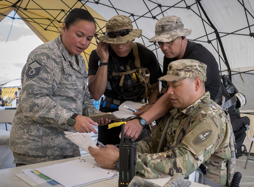 (Left) Master Sgt. Gloria Choo, 154th Medical Group Detachment 1 Medical Countermeasures NCO-in-charge, and (right) Lt. Col. Marlon Rimando, Det. 1 Medical Countermeasures Joint Task Force Surgeon, provide Hawaii Army National Guard’s decontamination team leaders a brief on current mission hazards March 9, 2019, at Kalaeloa, Hawaii. The Medical Countermeasures Team’s primary mission is to ensure the health and wellbeing (Air National Guard photo by Senior Airman John Linzmeier)