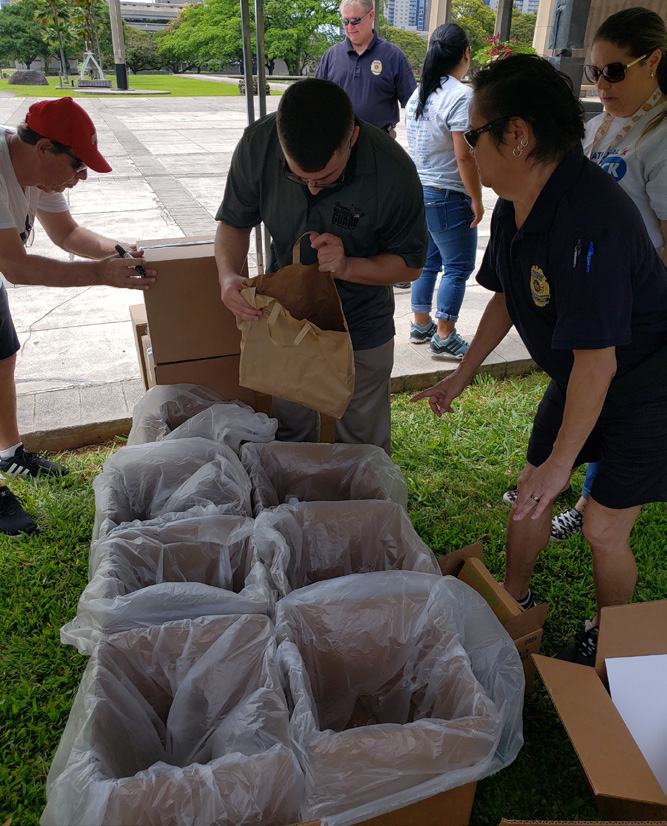 Second Lt. Shaun Garcia of the HING Counterdrug Office collects expired or unused drugs during the DEA National Take-Back Initiative.